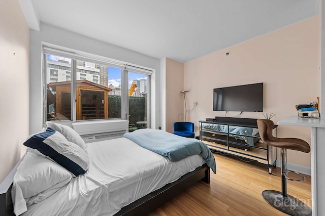 bedroom featuring baseboards and wood finished floors
