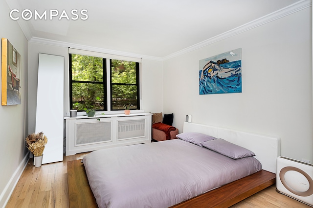 250 W 15th St Unit 3C, New York City, NY 10011 - bedroom featuring crown molding, wood finished floors, and baseboards