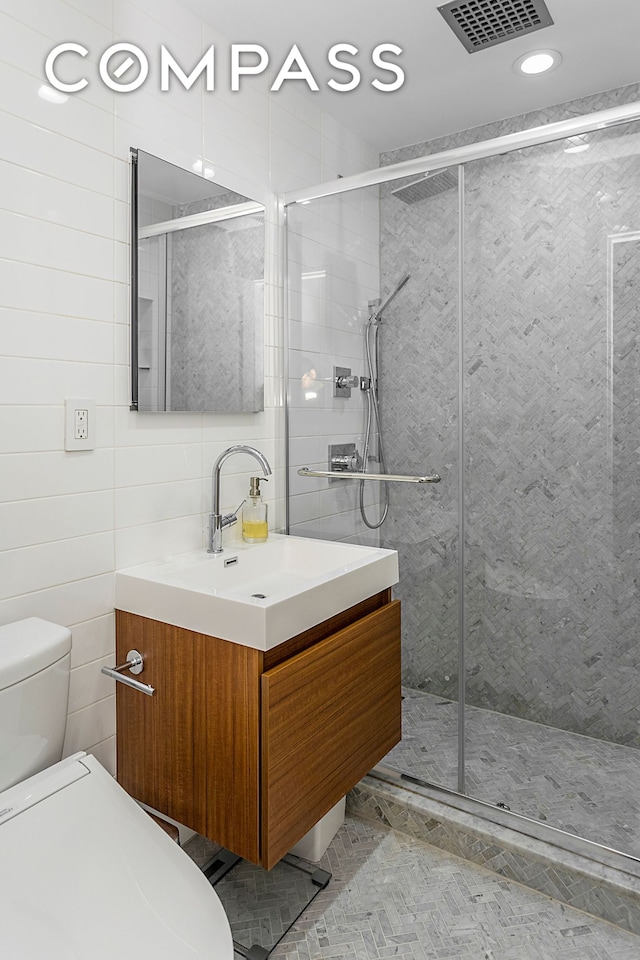 250 W 15th St Unit 3C, New York City, NY 10011 - full bath featuring vanity, toilet, tile walls, a shower stall, and recessed lighting