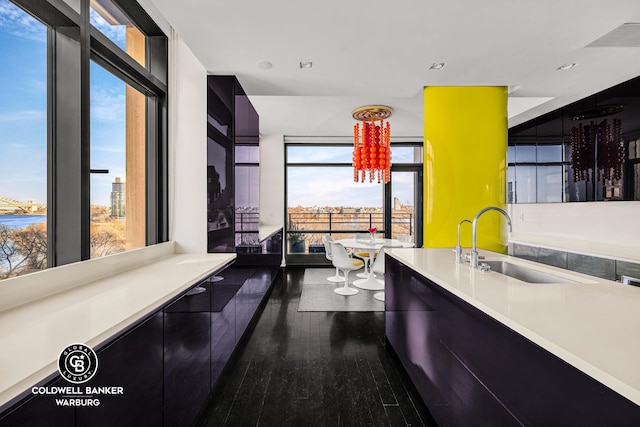 170 E End Ave Unit 8/9E, New York City, NY 10128 - kitchen with a sink, modern cabinets, dark cabinets, light countertops, and recessed lighting