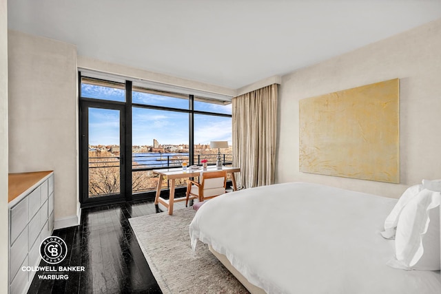 170 E End Ave Unit 8/9E, New York City, NY 10128 - bedroom featuring dark wood-type flooring and baseboards