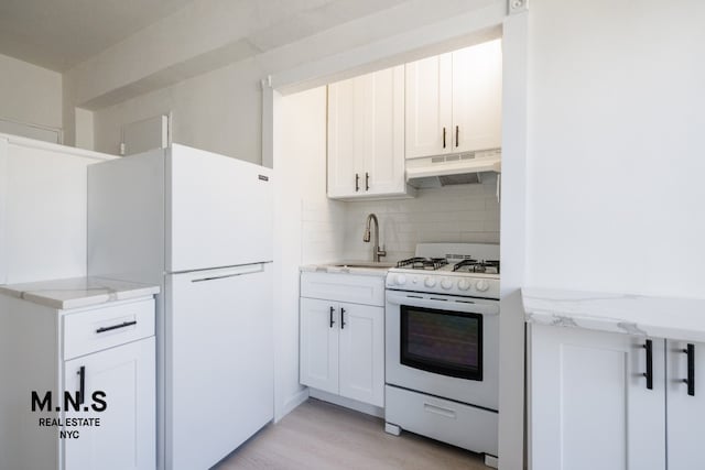 98-19 64th Ave Unit 6-Gg, New York City, NY 11374 - kitchen with white appliances, under cabinet range hood, a sink, decorative backsplash, and white cabinets