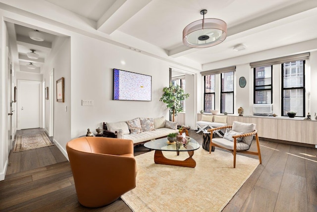 living room with beamed ceiling, hardwood / wood-style flooring, and baseboards