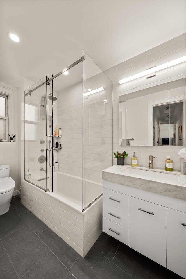 full bathroom with toilet, tiled shower / bath combo, tile patterned flooring, vanity, and recessed lighting