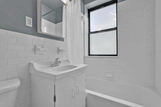 7 2nd Ave Unit 2-B, New York City, NY 10003 - full bathroom with vanity, shower / bathtub combination with curtain, and tile walls