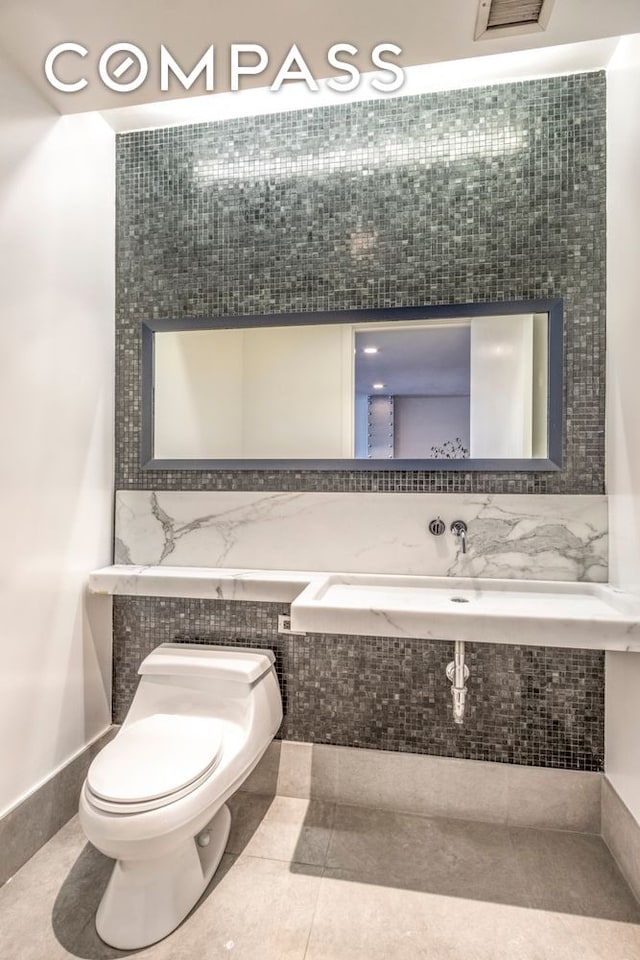 150 Nassau St Unit 18Ab, New York City, NY 10038 - bathroom featuring toilet, tile patterned floors, and a sink