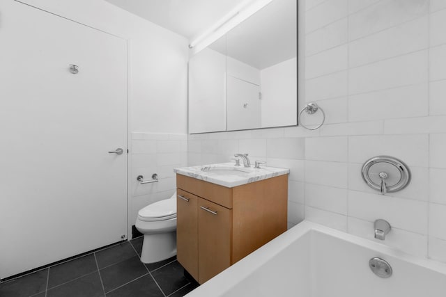 230 Ashland Pl Unit 11D, New York City, NY 11217 - bathroom featuring tile walls, tile patterned floors, vanity, and toilet