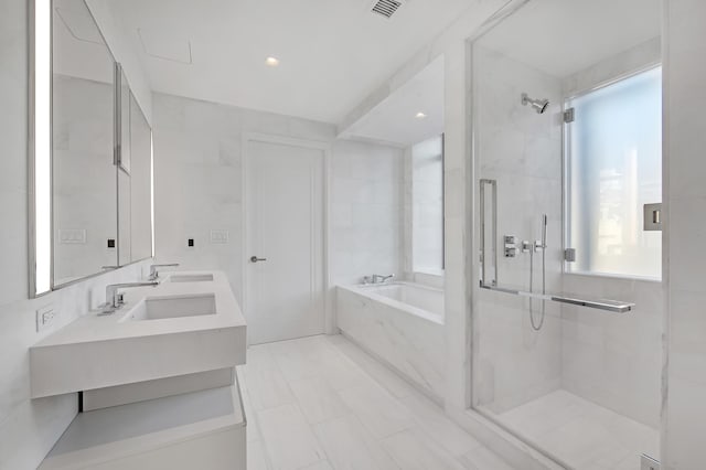 269 W 87th St Unit 14-A, New York City, NY 10024 - bathroom with a sink, double vanity, visible vents, a garden tub, and a stall shower