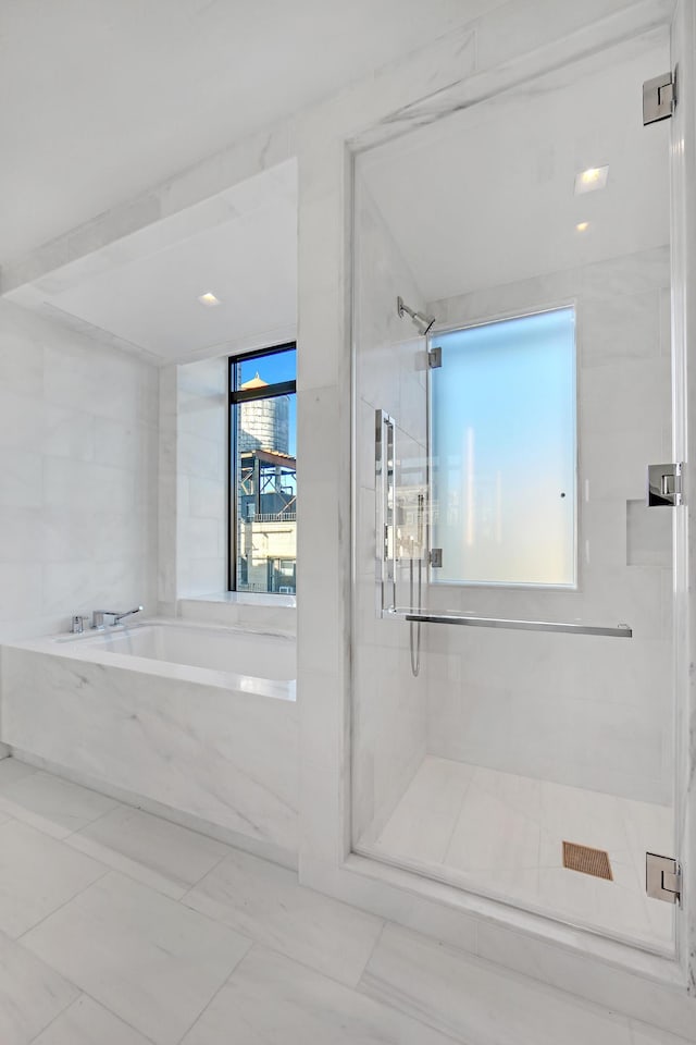 bathroom with a bath and a shower stall