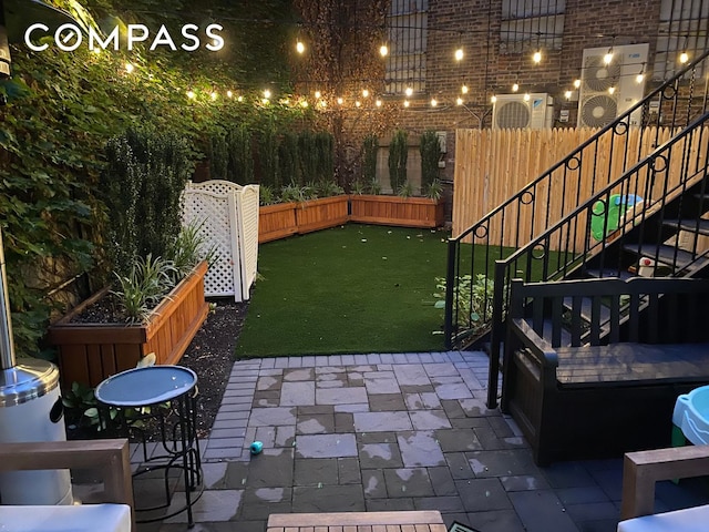 view of patio featuring stairs and fence