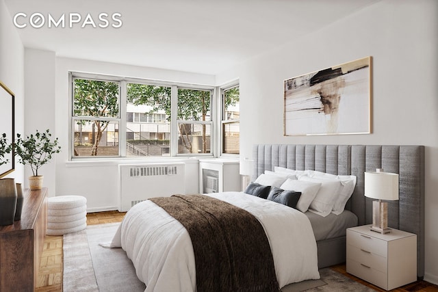 bedroom featuring radiator and baseboards