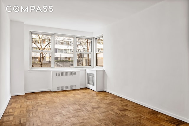 bar area with radiator heating unit and baseboards