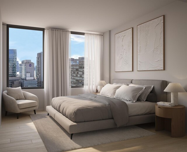 bedroom with light wood-style flooring and a city view