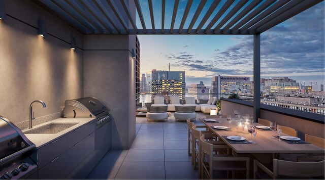 balcony at dusk featuring area for grilling, outdoor dining space, a view of city, and a sink