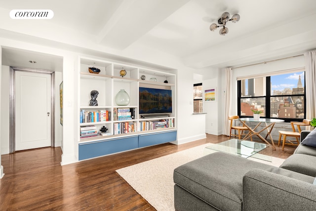 living area featuring baseboards and wood finished floors