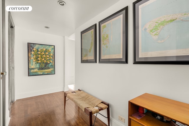 hallway with wood finished floors and baseboards