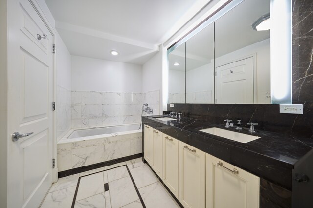 205 E 85th St Unit 8K, New York City, NY 10028 - full bath featuring double vanity, a bath, marble finish flooring, and backsplash