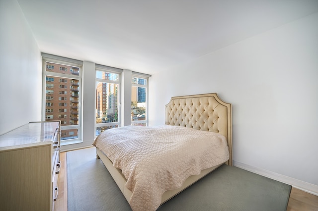 205 E 85th St Unit 8K, New York City, NY 10028 - bedroom with baseboards and light wood-type flooring