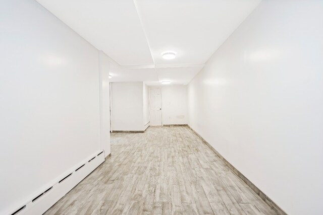309 Covert St, New York City, NY 11237 - unfurnished room featuring a baseboard radiator and light wood-type flooring
