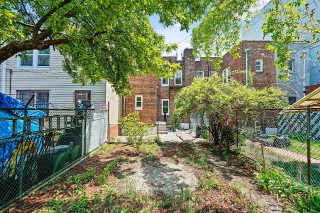 309 Covert St, New York City, NY 11237 - rear view of house featuring brick siding