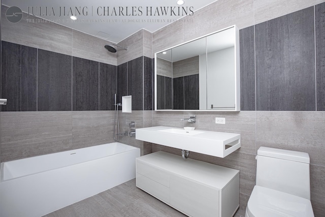 540 W 49th St Unit 307S, New York City, NY 10019 - full bathroom featuring tile walls and bathtub / shower combination