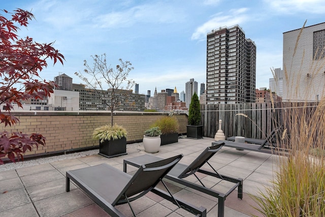 view of patio / terrace with a skyline view and fence