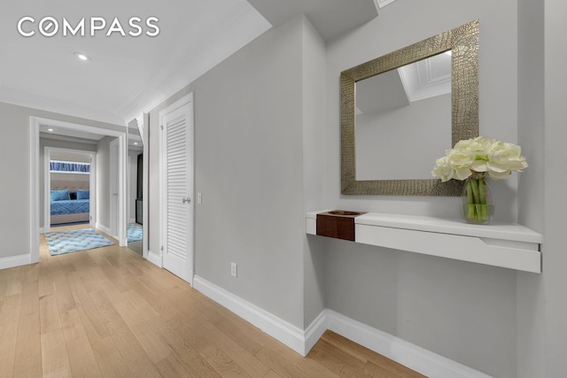 hall featuring recessed lighting, light wood-type flooring, baseboards, and ornamental molding
