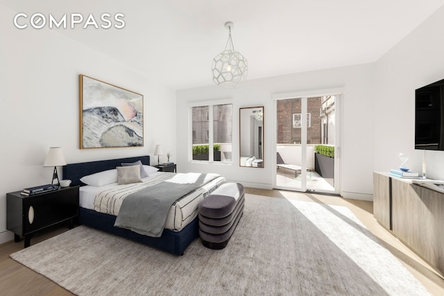 54 E 80th St, New York City, NY 10075 - bedroom with multiple windows, wood finished floors, access to outside, and baseboards