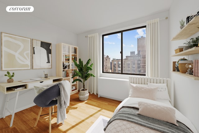 181 7th Ave Unit 14A, New York City, NY 10011 - bedroom with light wood finished floors, an office area, and a view of city