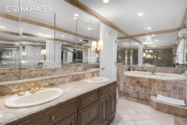 full bath featuring a sink, tile patterned floors, double vanity, and a garden tub