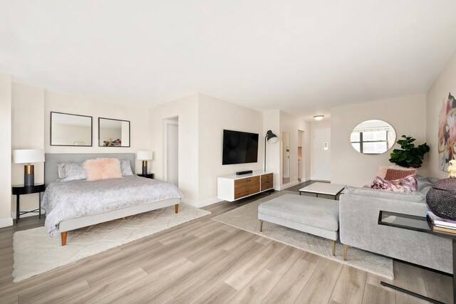 bedroom featuring baseboards and wood finished floors
