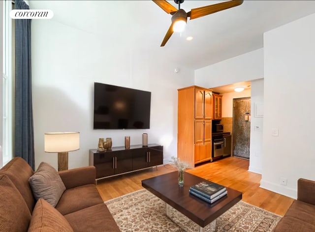 458 W 20th St Unit 2A, New York City, NY 10011 - living area featuring a ceiling fan, light wood-style flooring, and baseboards