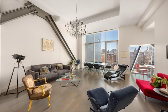 living area with a chandelier, wood finished floors, and a city view