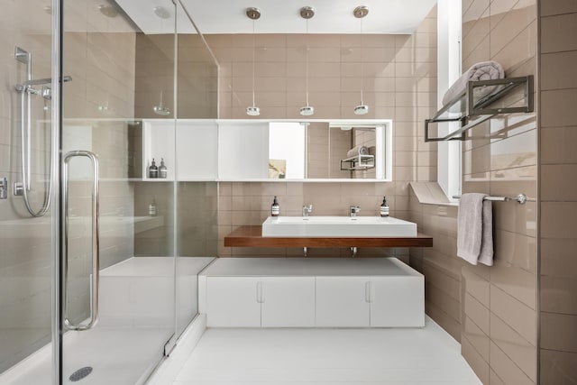 full bathroom featuring tile walls, a stall shower, tasteful backsplash, and vanity