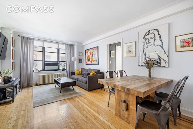 235 E 22nd St Unit 4T, New York City, NY 10010 - dining room with radiator, light wood-style flooring, and ornamental molding