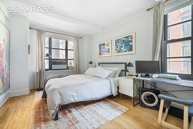235 E 22nd St Unit 4T, New York City, NY 10010 - bedroom with hardwood / wood-style floors, baseboards, and a desk
