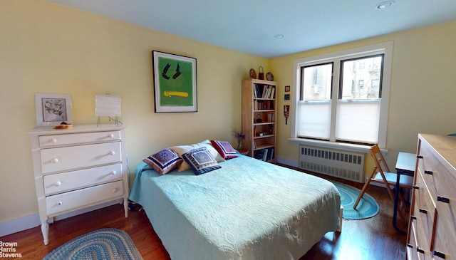 2244 Bronx Park E Unit 1B, New York City, NY 10467 - bedroom with radiator, dark wood finished floors, and baseboards