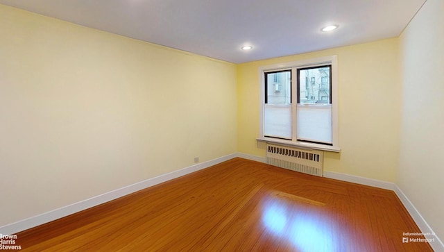 2244 Bronx Park E Unit 1B, New York City, NY 10467 - unfurnished room with radiator, baseboards, wood finished floors, and recessed lighting