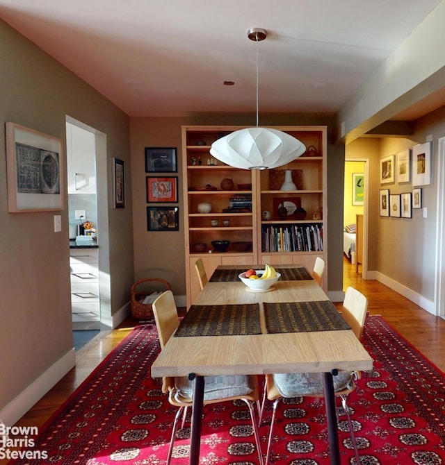 2244 Bronx Park E Unit 1B, New York City, NY 10467 - dining space featuring baseboards, wood finished floors, and built in features