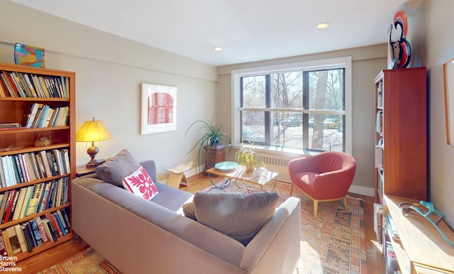 2244 Bronx Park E Unit 1B, New York City, NY 10467 - living area with wood finished floors, recessed lighting, and radiator heating unit