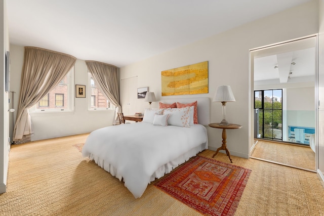 carpeted bedroom featuring access to exterior