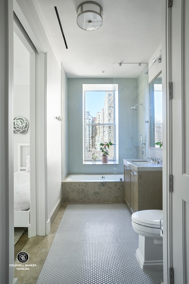 101 W 78th St Unit 5B, New York City, NY 10024 - bathroom with vanity, a tub with marble appearance, toilet, and a shower