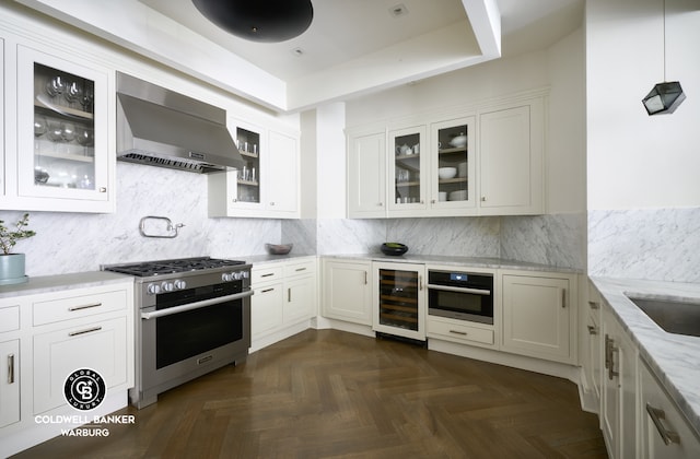 101 W 78th St Unit 5B, New York City, NY 10024 - kitchen with stainless steel range, beverage cooler, wall chimney exhaust hood, light stone countertops, and wall oven