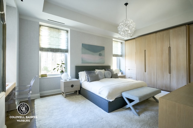 101 W 78th St Unit 5B, New York City, NY 10024 - bedroom with a chandelier, a tray ceiling, and baseboards