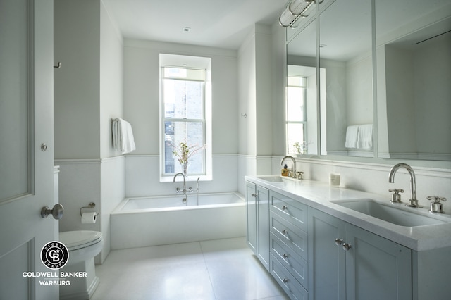 101 W 78th St Unit 5B, New York City, NY 10024 - full bathroom with toilet, double vanity, a garden tub, and a wainscoted wall
