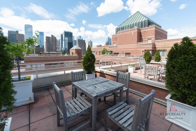 350 W 50th St Unit 6-R, New York City, NY 10019 - view of patio / terrace with outdoor dining area and a skyline view