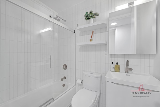 350 W 50th St Unit 6-R, New York City, NY 10019 - bathroom with tile walls, bathtub / shower combination, toilet, vanity, and tasteful backsplash