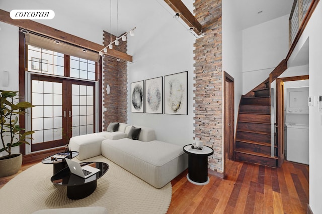 605 Manhattan Ave Unit 4, New York City, NY 11222 - bedroom featuring stacked washing machine and dryer, a high ceiling, hardwood / wood-style flooring, and french doors