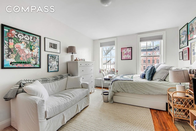 352 W 12th St Unit 5D, New York City, NY 10014 - bedroom featuring wood finished floors and radiator heating unit