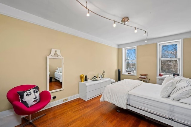 9437 Shore Rd Unit A1, New York City, NY 11209 - bedroom featuring wood finished floors, baseboards, and rail lighting